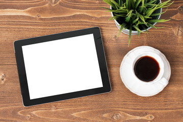 Tablet computer and coffie on wooden background
