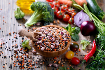 Lentils and beans in bowl, cooking ingredients with vegetables, vegetarian and vegan food concept,