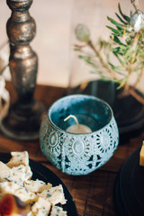 decorated tables with plates of cheese, candles, candlesticks, flowers