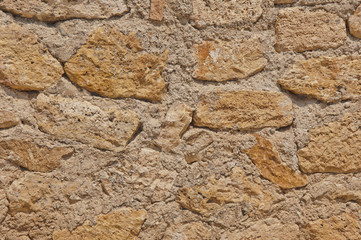Textured background. old beige stone wall
