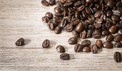Close up dark roasted Coffee beans on wood background