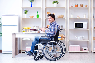 Disabled young man husband working in kitchen