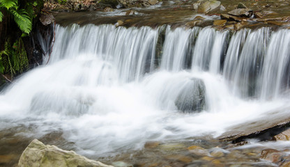 Fototapeta na wymiar Mountain waterfall landscape. Close-up