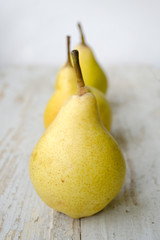 Ripe pears on a rustic wooden background.