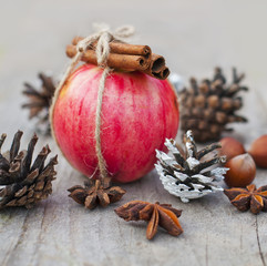 Fototapeta na wymiar dessert, apple with cinnamon and nuts, Christmas decor and food on a wooden table