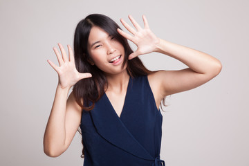 Young Asian woman sticking her  tongue out.