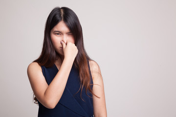 Fototapeta premium Young Asian woman holding her nose because of a bad smell.