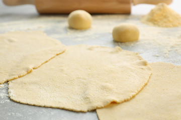 Rolled dough for tortillas on kitchen table