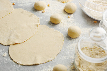 Rolled dough for tortillas on kitchen table