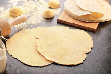 Rolled dough for tortillas on kitchen table