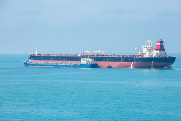 Transfer of oil in the open sea.