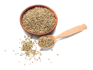 Bowl and spoon with hemp seeds on white background