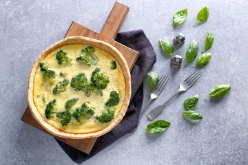 Tasty broccoli quiche on table