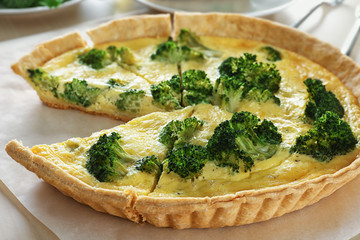 Tasty broccoli quiche on table