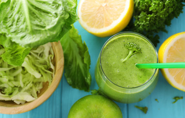 Healthy smoothie with kale in glass on table