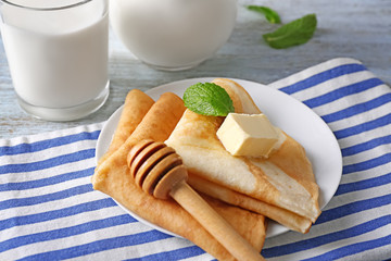 Delicious pancakes with butter on plate
