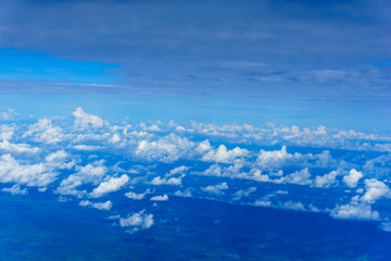 view of cloud and sky from the windows of airplane flying in sunny day at attitude 32000 feets