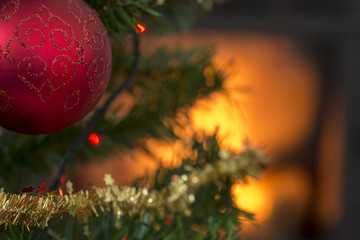Red ball on the branch of a decorated Xmas tree