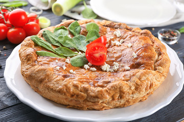 Tasty pie with spinach on plate