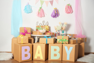 Composition with baby shower decorations and gifts indoors
