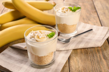 Glasses with yummy banana pudding on kitchen table