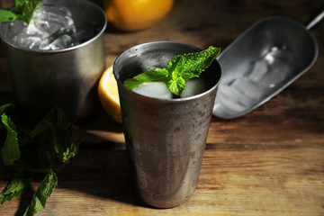 Metal glass with mint julep on kitchen table