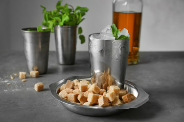 Composition with mint julep and brown sugar on kitchen table