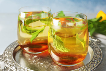 Two glasses with mint julep on metal tray