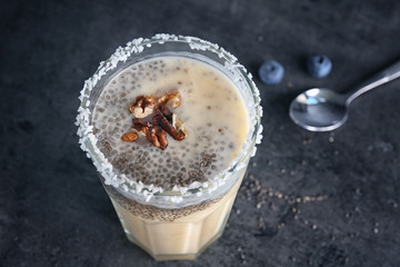 Smoothie with chia seeds in glass on table