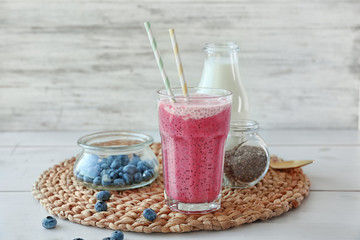 Smoothie with chia seeds in glass on table