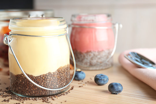 Smoothies with chia seeds in jars on table