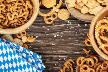 Beer snacks on a wooden table.Bavarian oktoberfest napkin. Top view with copy