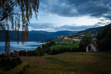 Fototapeta na wymiar Hafslovatnet lake at night with city