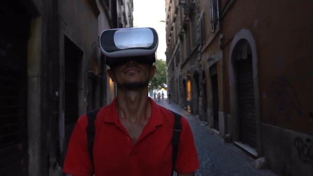 Tourist Man wearing virtual reality headset walking on streets of Rome, Italy. VR technology.