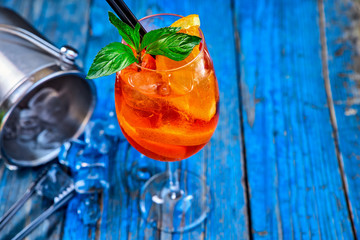 Spritz Aperol cocktail in wine glass on rustic wooden background