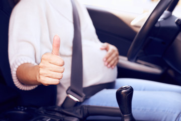Pregnant woman hand showing thumb up
