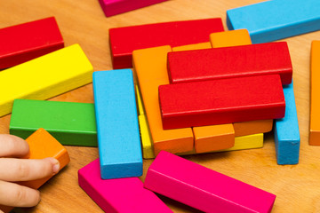 Scattered heap of toy colored wooden bricks