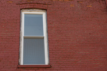 Window on red brick wall