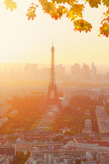 Eiffel Tower and Paris cityscape from above in orange autumn sunset sunlight, France