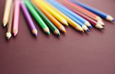 Colorful pencils on a gray background. 