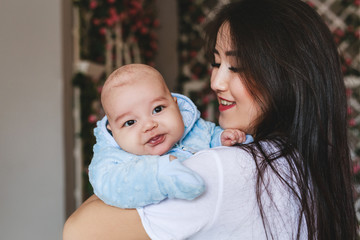 Portrait of a happy young Japanese or Asian mom and her baby
