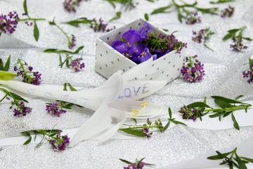 The box is filled with purple flowers on the surface covered