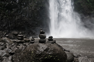 Zen stone at waterfall with blur background