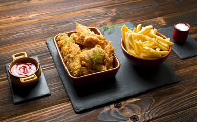 French fries and nuggets on a dark background