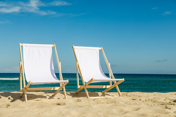 Deck chairs on beach  - obrazy, fototapety, plakaty