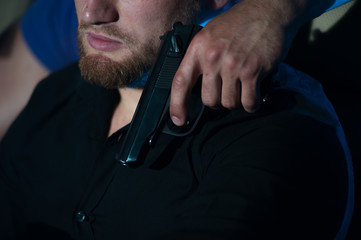 Criminal person pointing gun at the driver