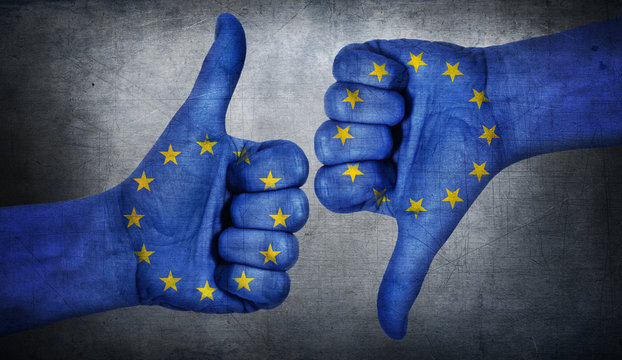  Hand with thumb up and down with the EU flag painted.  Symbol of positivity and crisis in european union.