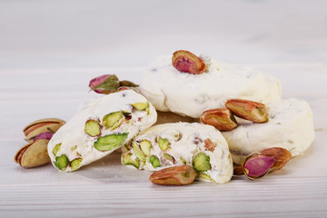 Close up Traditional Iranian and Persian pieces of white nougat dessert sweet candies (Gaz) with Pistachio nuts from Isfahan City
