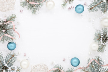 Stylish Frame with New Year decor and fir, frosty blue and pearly balls. Snowy texture.