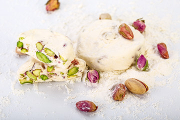 Close up Traditional Iranian and Persian pieces of white nougat dessert sweet candies (Gaz) with...